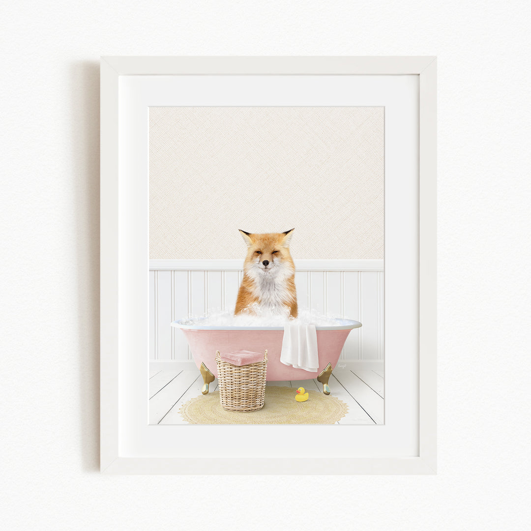A red fox is sitting in a pink bathtub filled with bubbles, surrounded by rubber ducks and a basket.