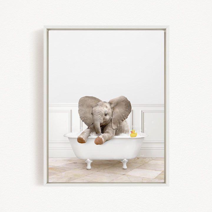 A baby elephant sitting in a white bathtub, with a rubber duck floating nearby.