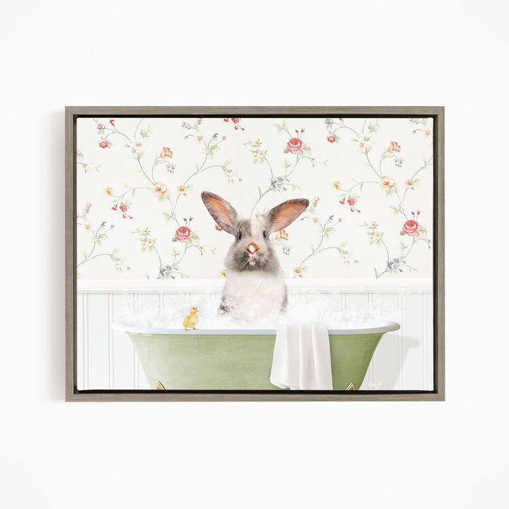 A fluffy gray rabbit sits in a green bathtub filled with bubbles, surrounded by a floral wallpaper.
