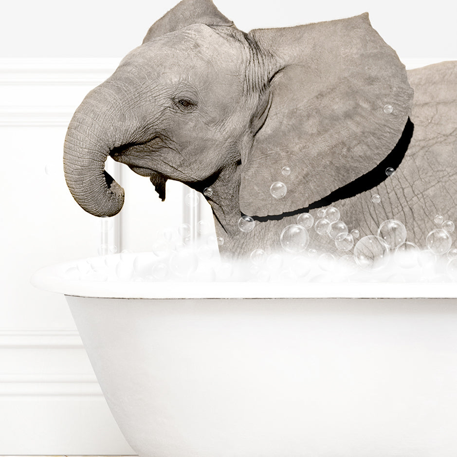 a baby elephant taking a bath in a bathtub