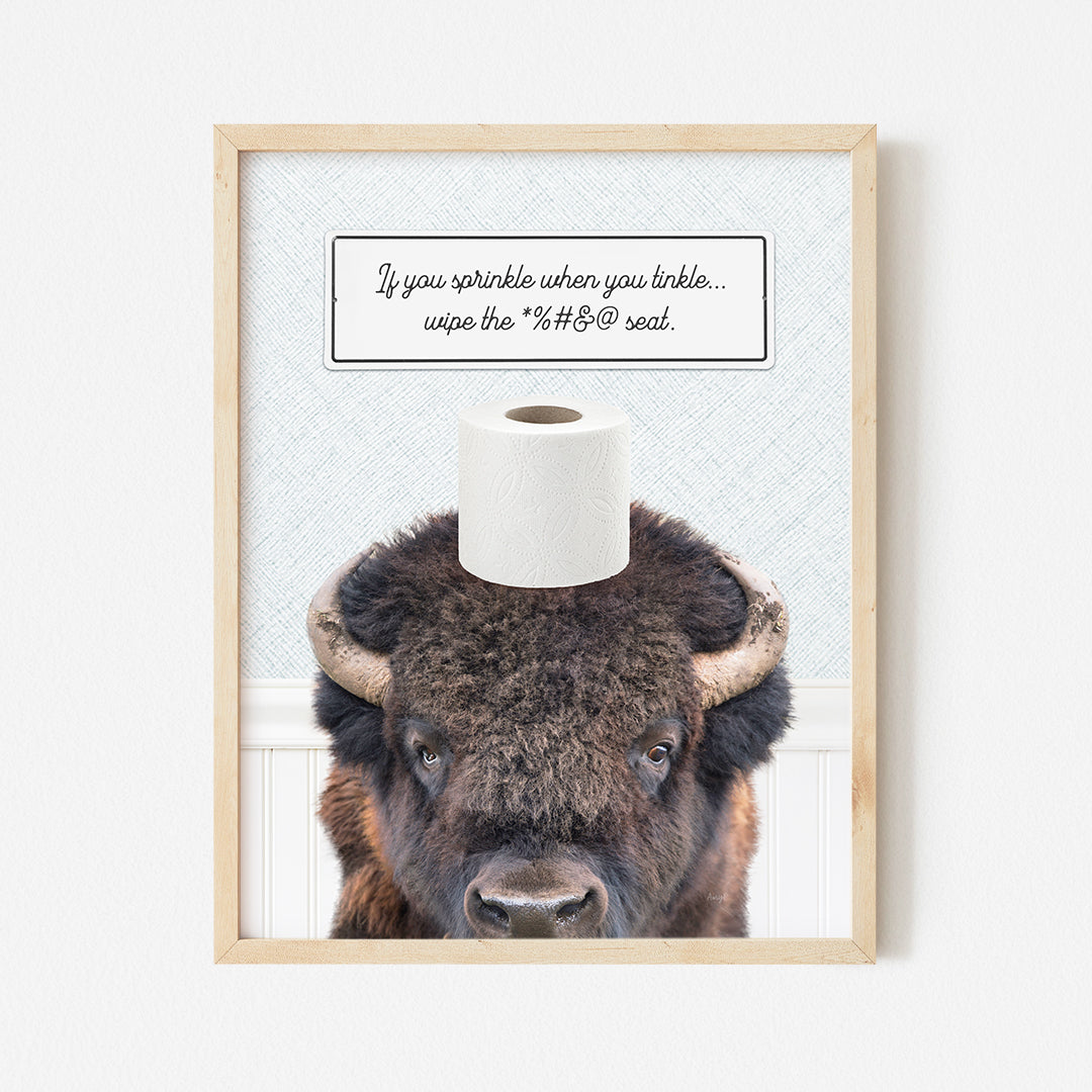 a picture of a bison with a roll of toilet paper on it's head