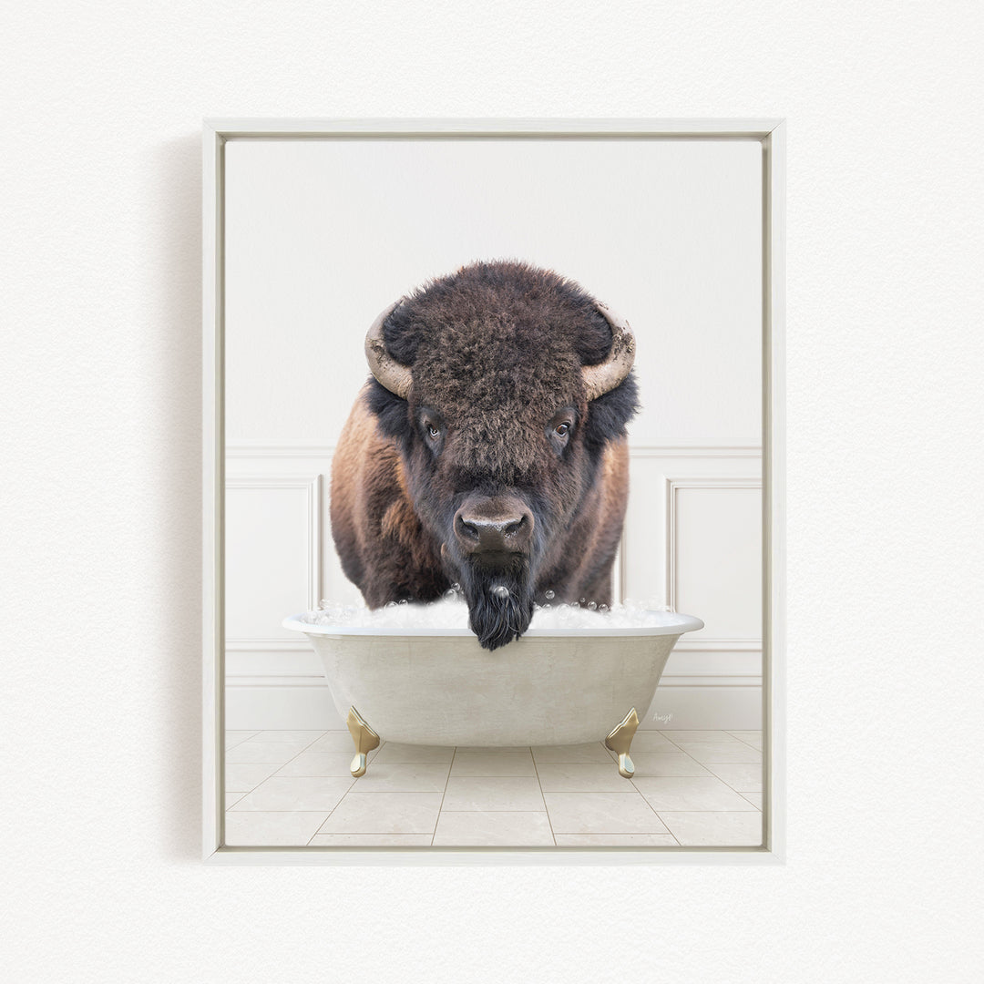A buffalo with a long beard is standing in a white bathtub, looking directly at the camera.