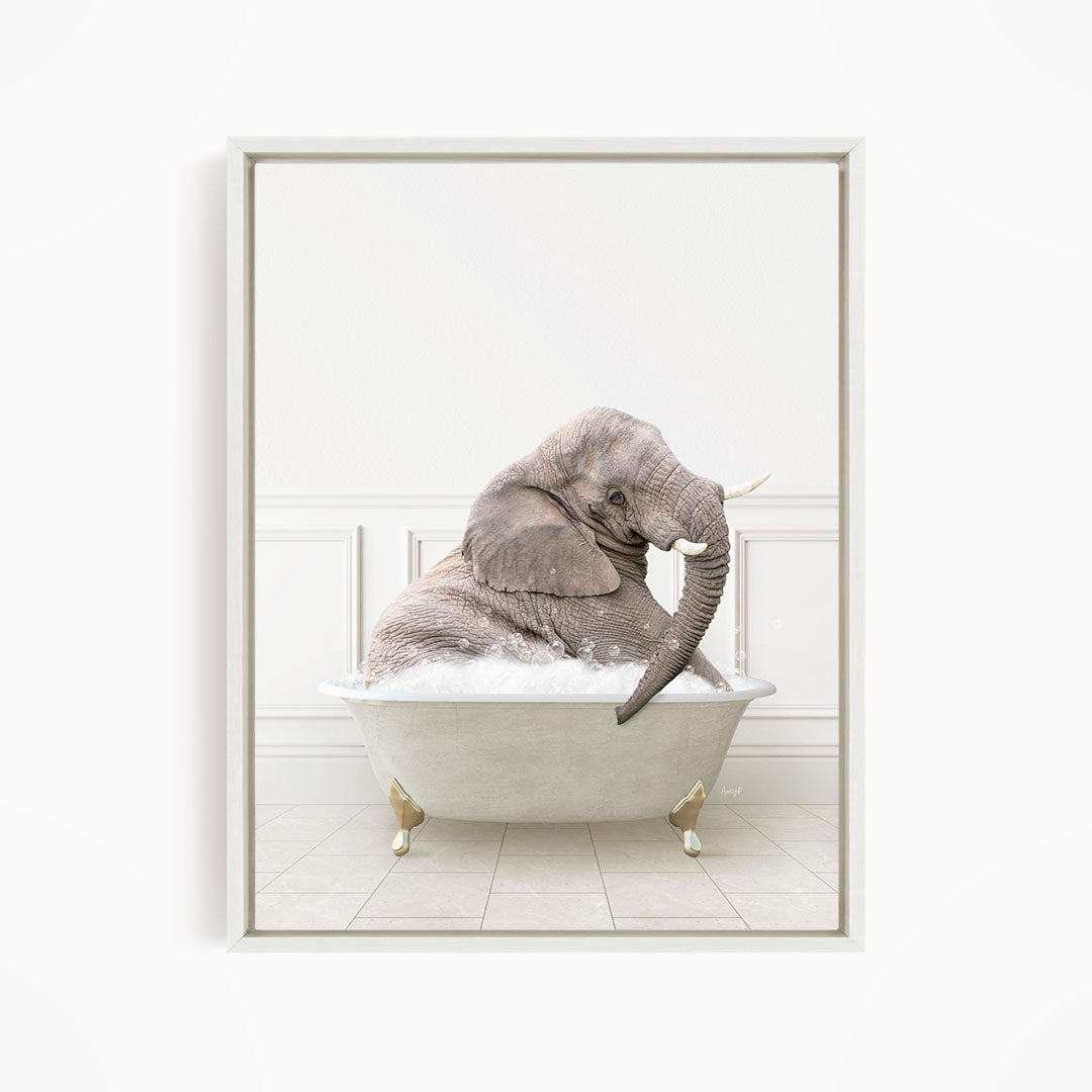 A gray elephant is sitting in a white bathtub filled with water, with its trunk raised in the air.