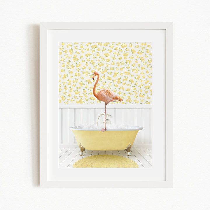 A pink flamingo stands on a yellow bathtub in a bathroom with yellow floral wallpaper.