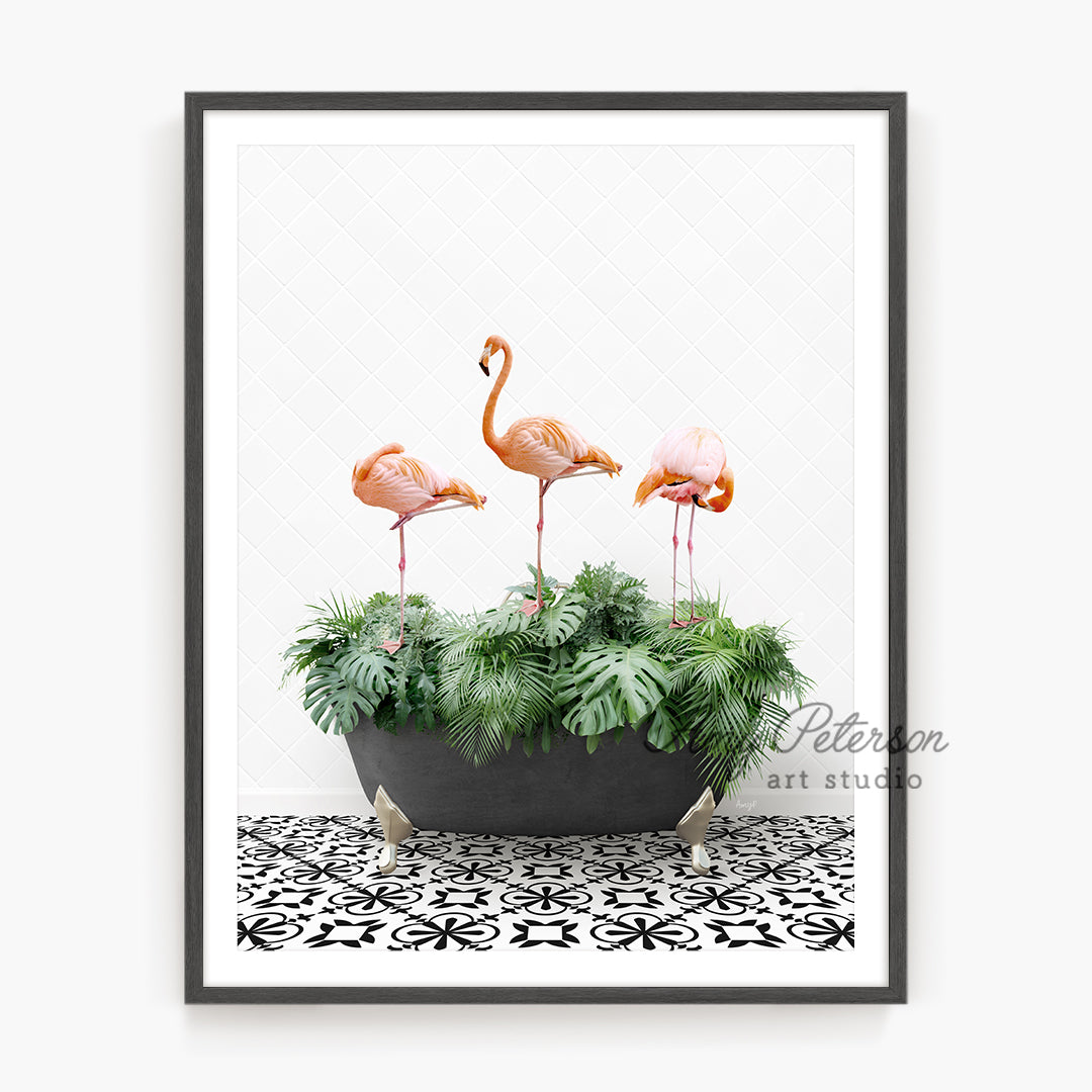 three pink flamingos in a planter on a tiled floor