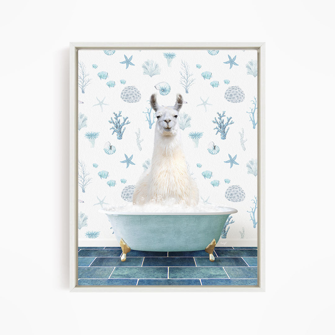 A white llama sitting in a blue bathtub filled with bubbles, surrounded by a pattern of blue and white seashells and starfish.