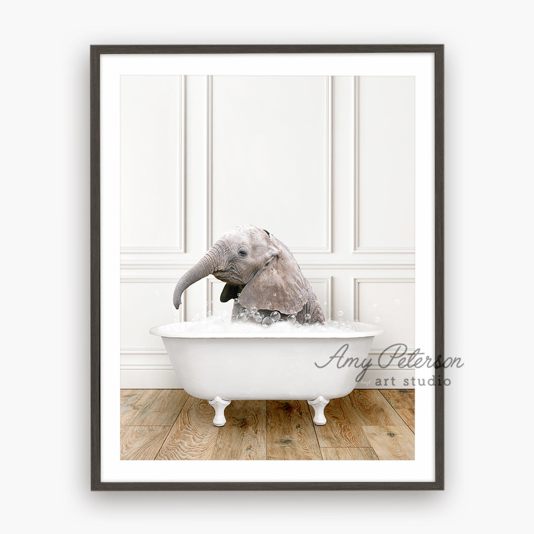 a framed photograph of an elephant in a bathtub