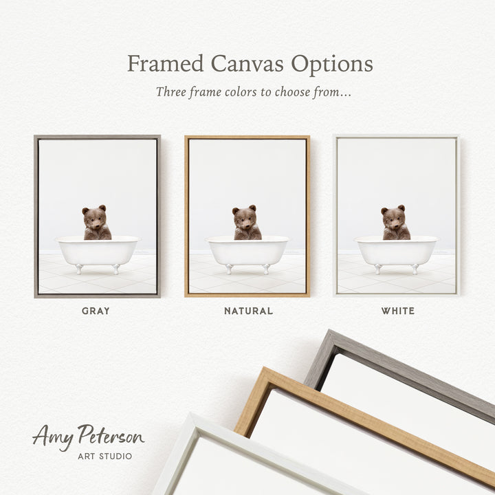 three framed canvas options, each featuring a small brown bear sitting in a white bathtub. The options include a gray frame, a natural frame, and a white frame.