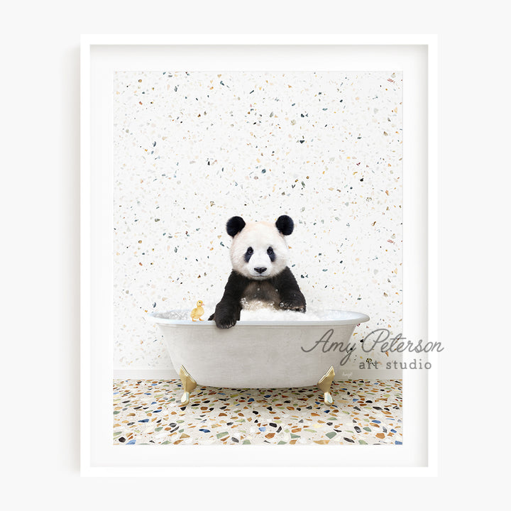 a black and white panda bear sitting in a bathtub