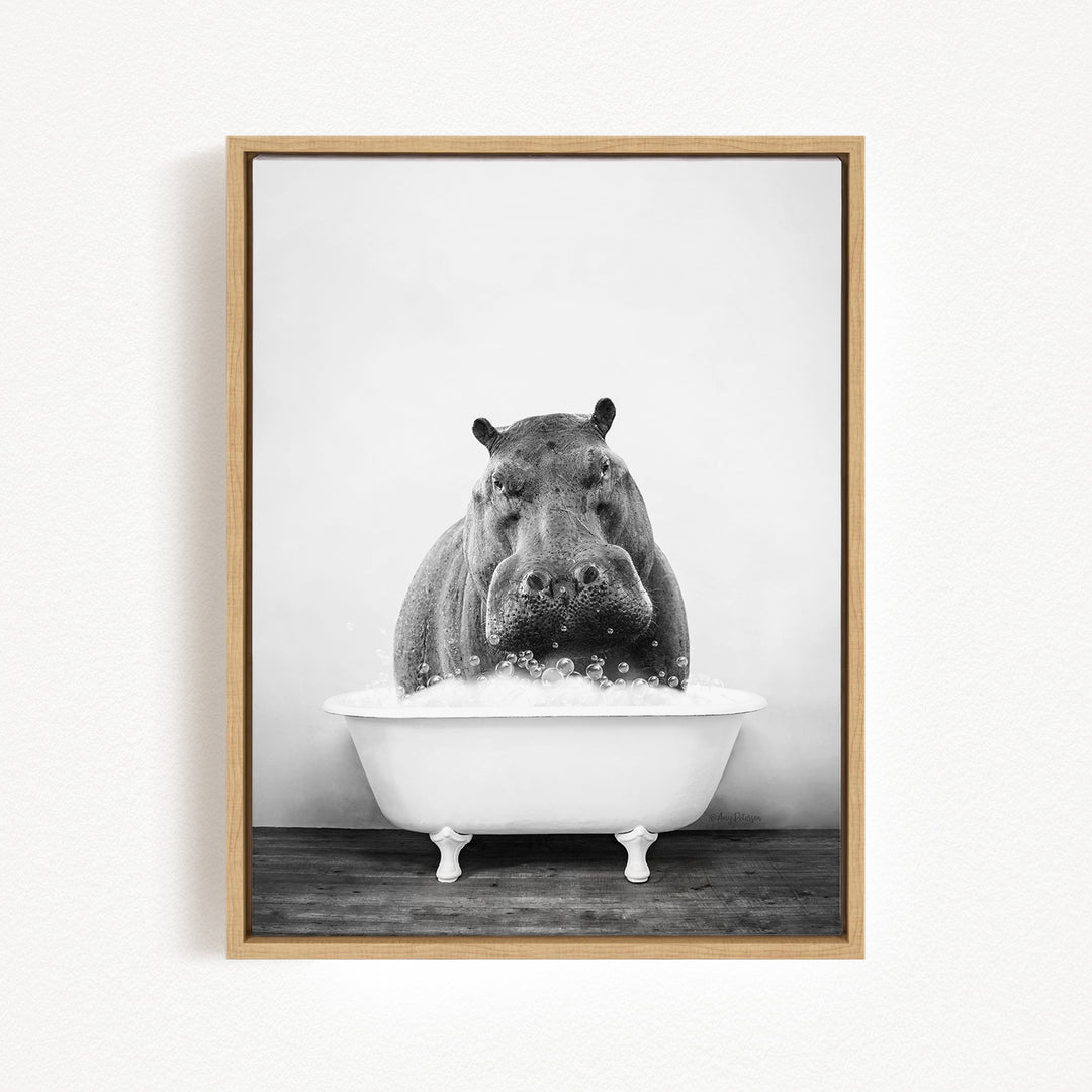 A black and white photograph of a hippopotamus sitting in a bathtub filled with water, creating a playful and whimsical scene.