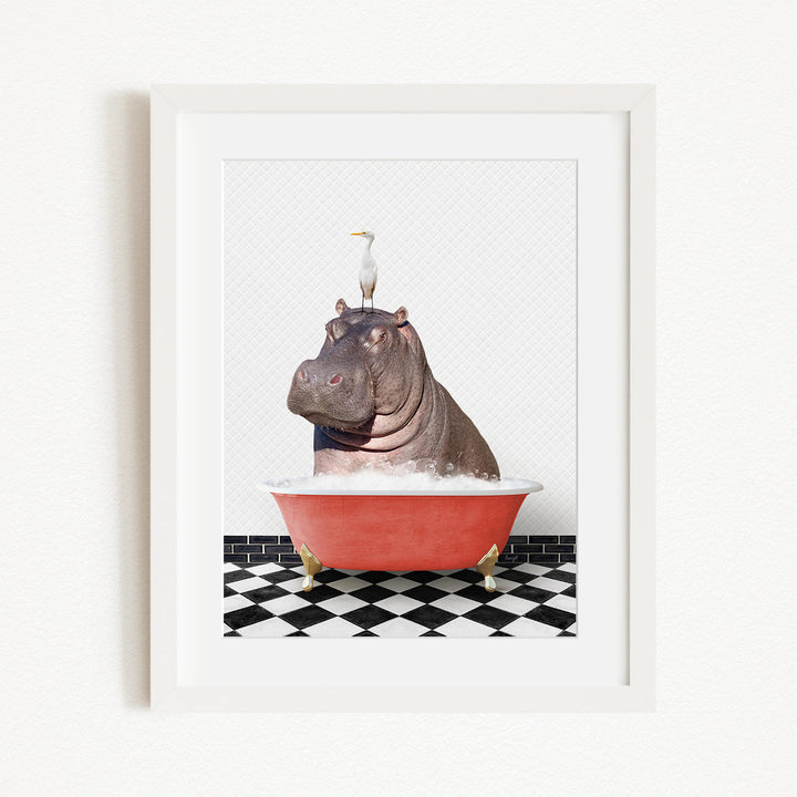 A framed image depicting a large, brown hippopotamus sitting in a red bathtub, with a seagull perched on its head.