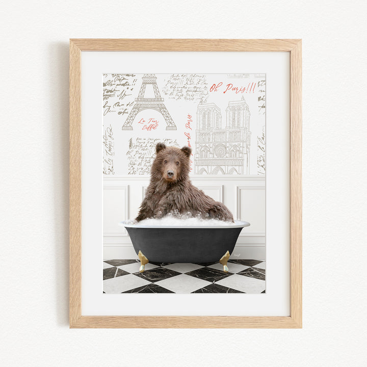 A brown bear sitting in a bathtub filled with water, surrounded by a checkered floor and a framed image of the Eiffel Tower in the background.