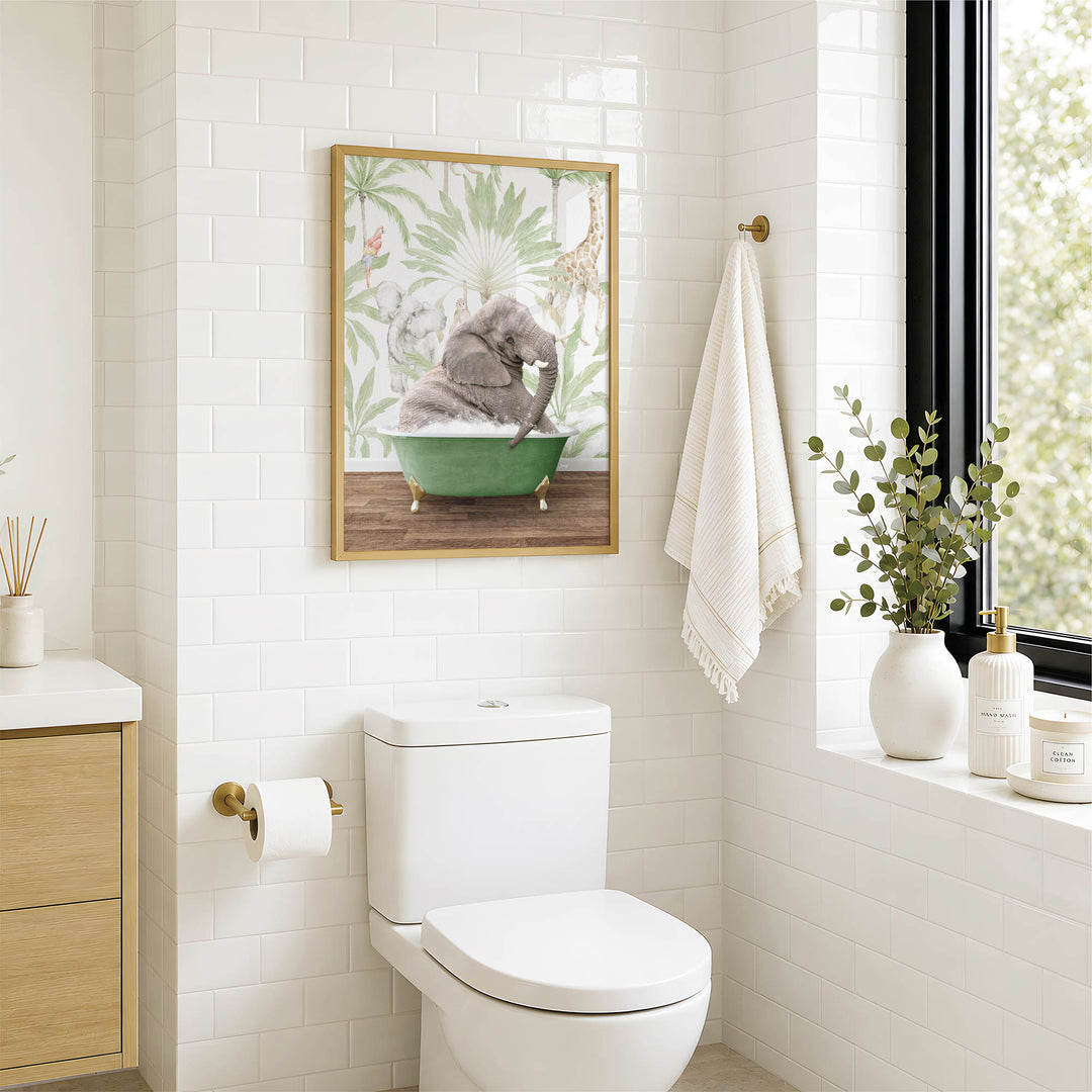 A bathroom with a white toilet, a framed picture of an elephant in a bathtub, and a window with greenery on the sill.
