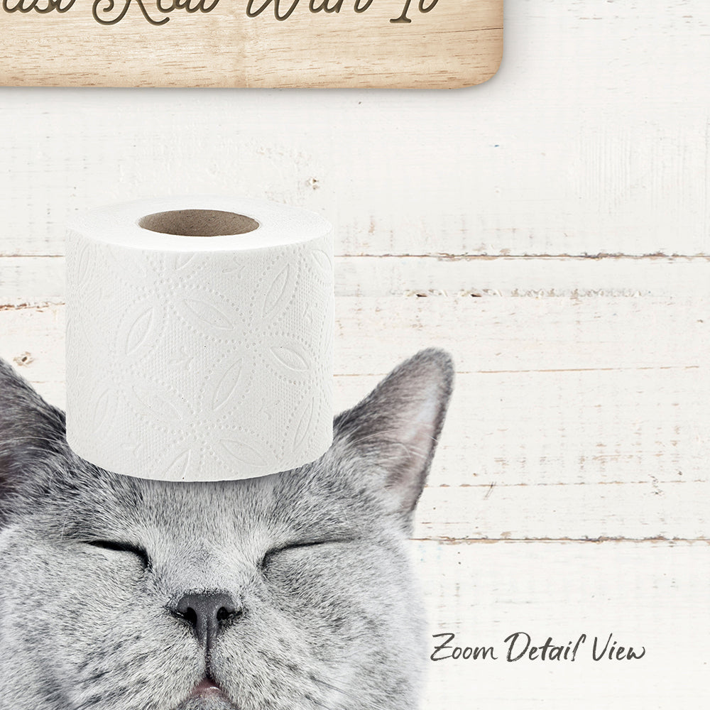 A gray cat with its eyes closed, resting its head on a roll of toilet paper, with a wooden sign above it that says "Wat it".