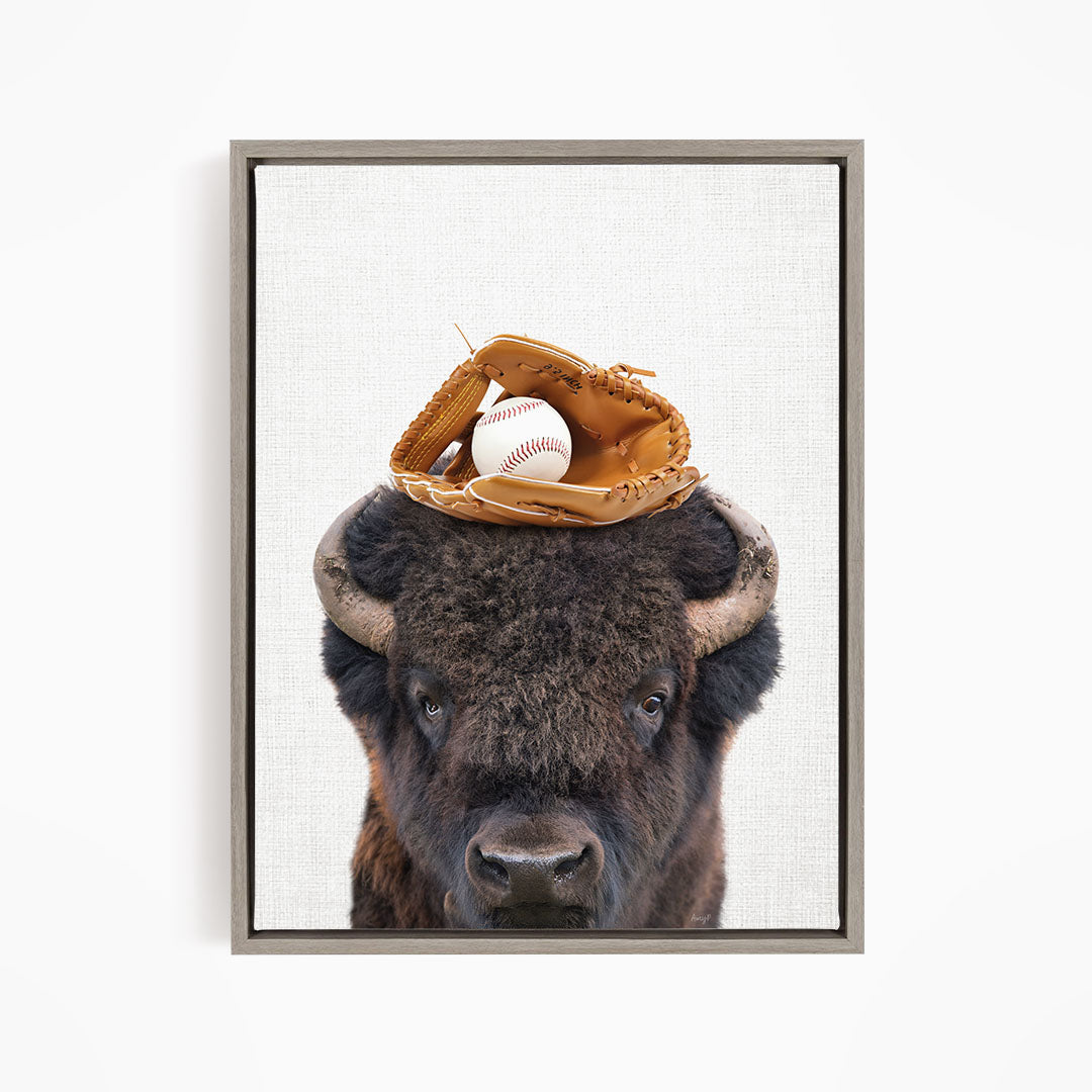 A buffalo with a baseball glove on its head.