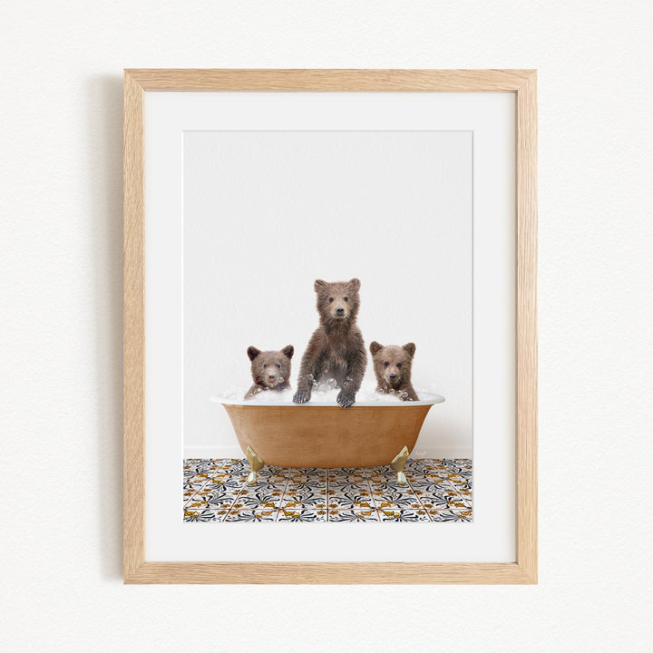 A framed image of three bears sitting in a bathtub, with one bear sitting in the center and the other two bears sitting on either side.