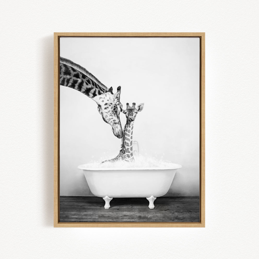 A mother giraffe and her baby giraffe enjoying a bath together in a white bathtub.