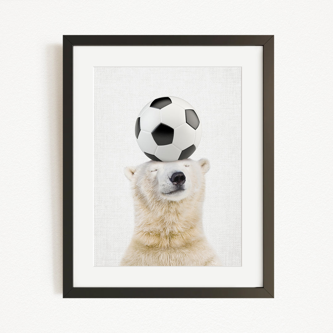 A polar bear balancing a soccer ball on its head.