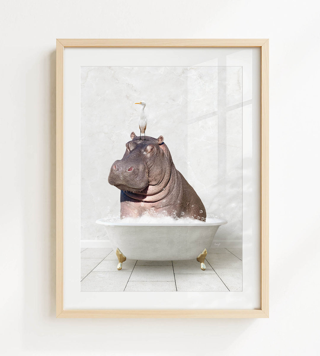 A framed image depicting a hippopotamus sitting in a bathtub, with a bird perched on its head.