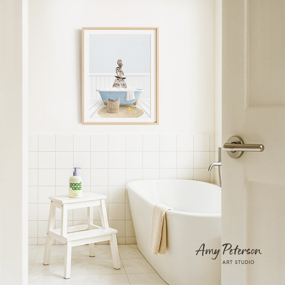 a bathroom with a white bathtub, a stool, and a framed picture of a woman sitting in a bathtub.