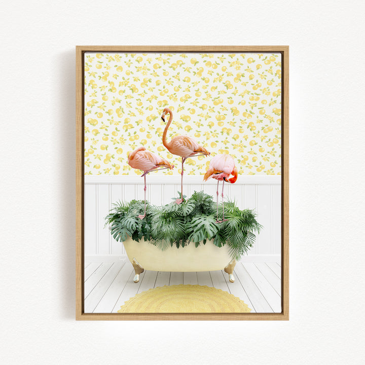 A framed image depicting three pink flamingos standing in a bathtub filled with green plants, set against a yellow and white floral background.