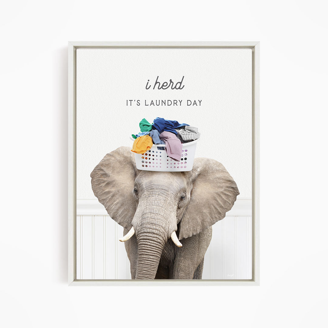 A gray elephant holding a laundry basket on its head, with the text "It's laundry day" above it.