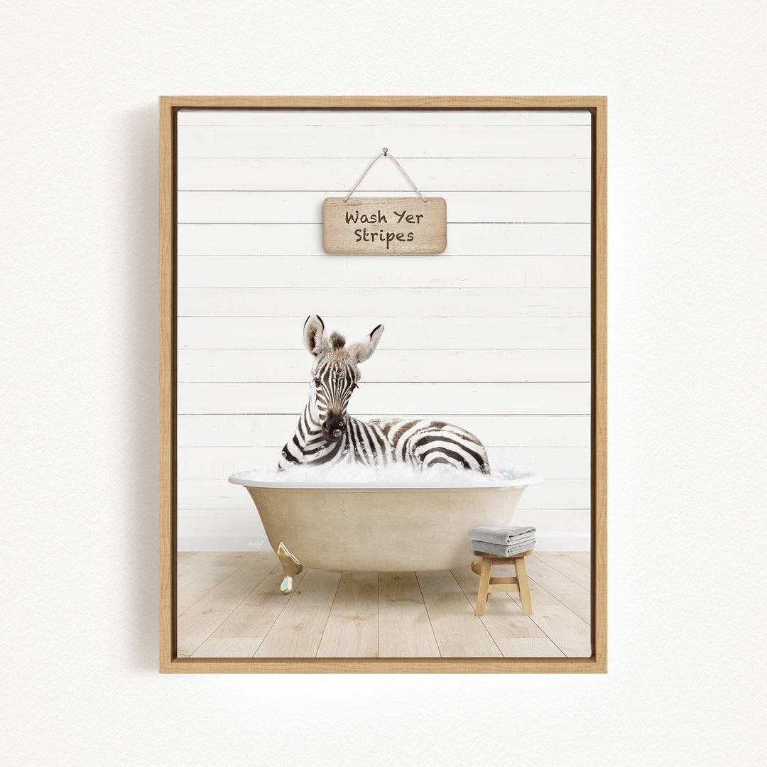A zebra sitting in a bathtub, with a sign above it that says "Wash Yer Stripes".