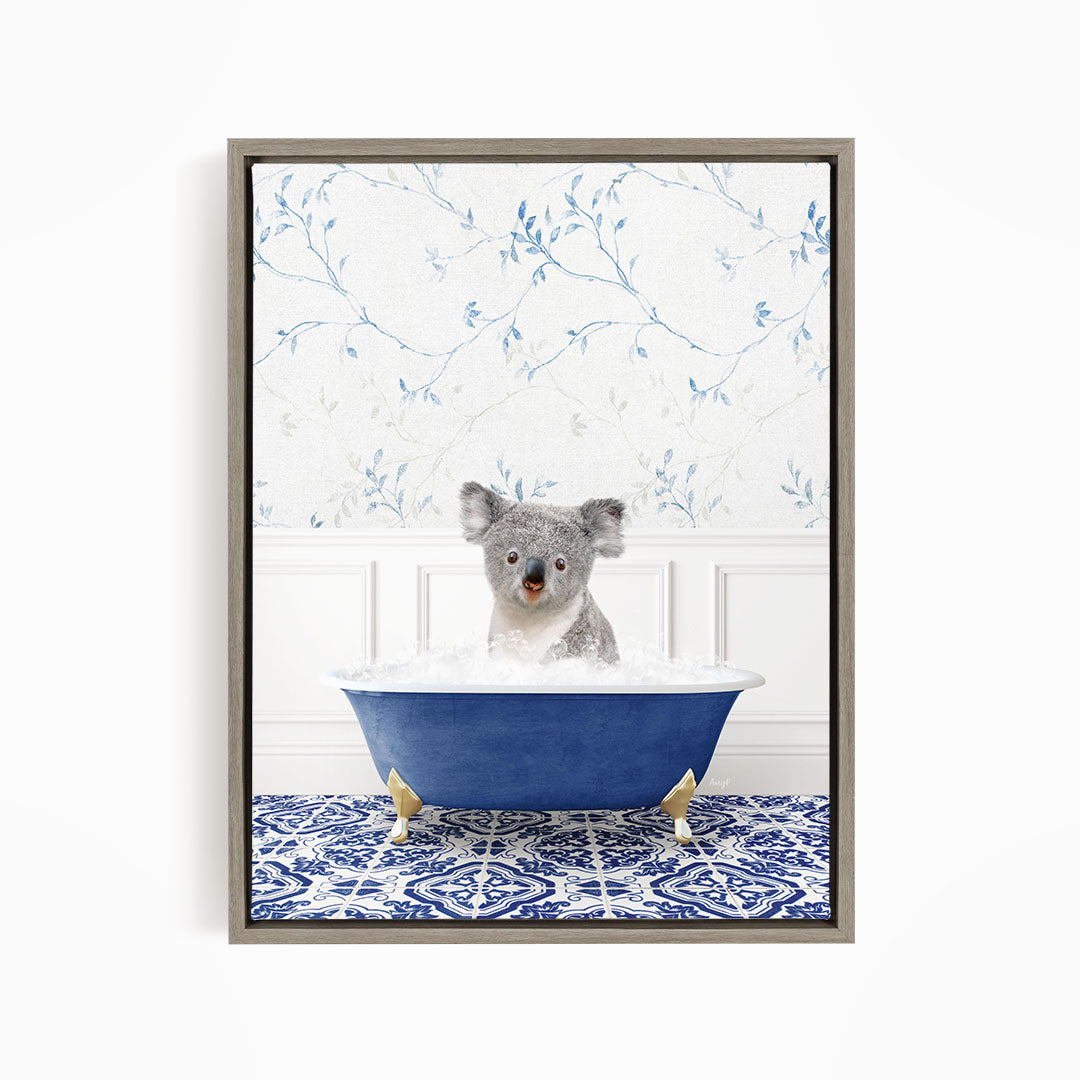 A koala bear sitting in a blue bathtub filled with water, surrounded by a blue and white patterned floor.