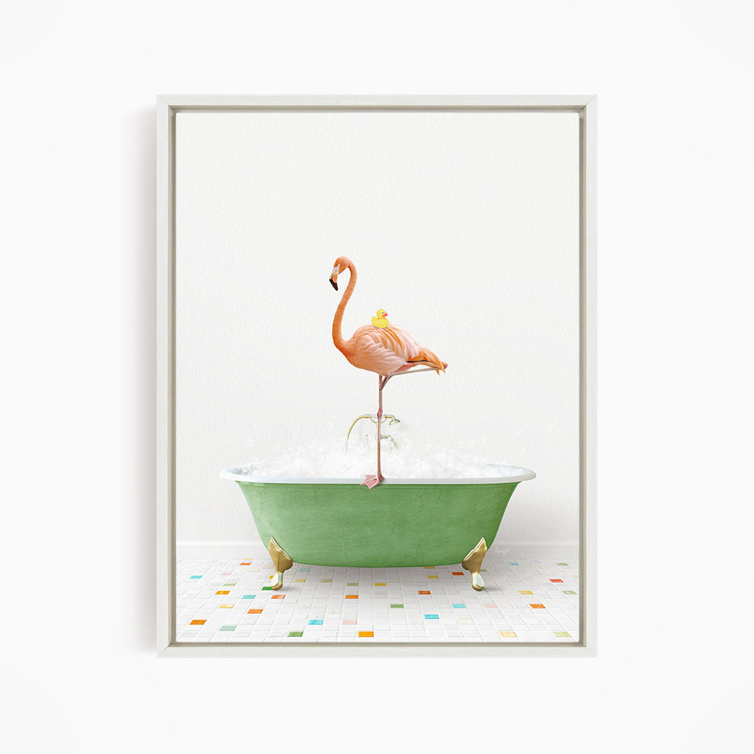 A pink flamingo stands on a green bathtub filled with bubbles, with a yellow duck perched on its back.