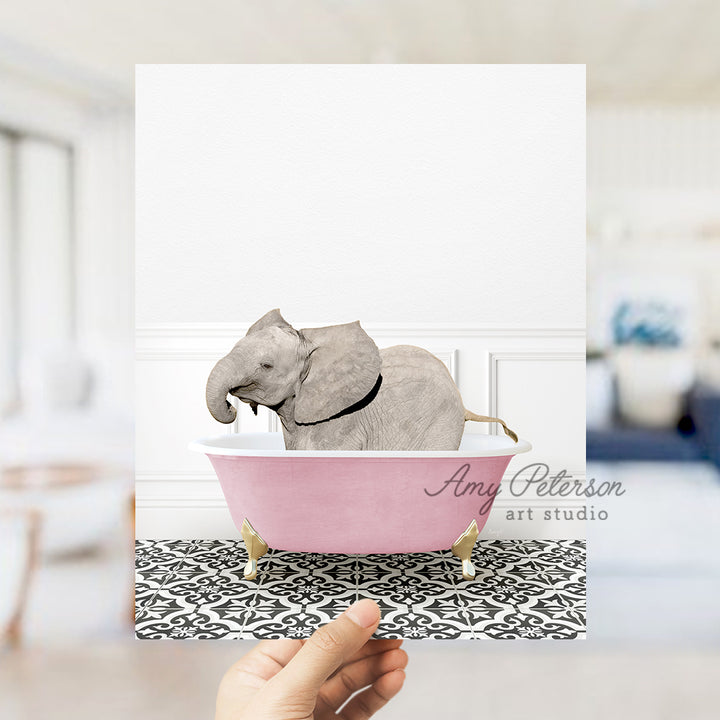 a hand holding a card with an elephant in a bathtub