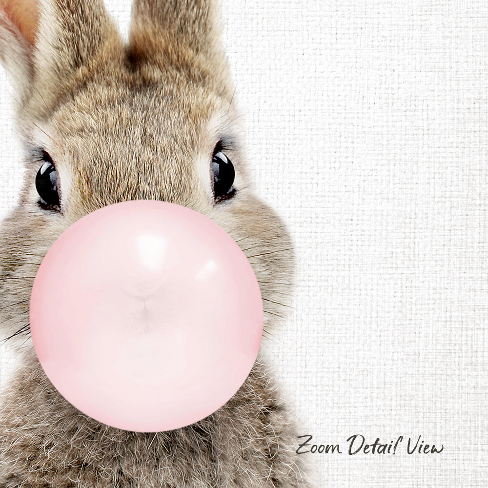 A cute brown rabbit blowing a pink bubble with its nose.