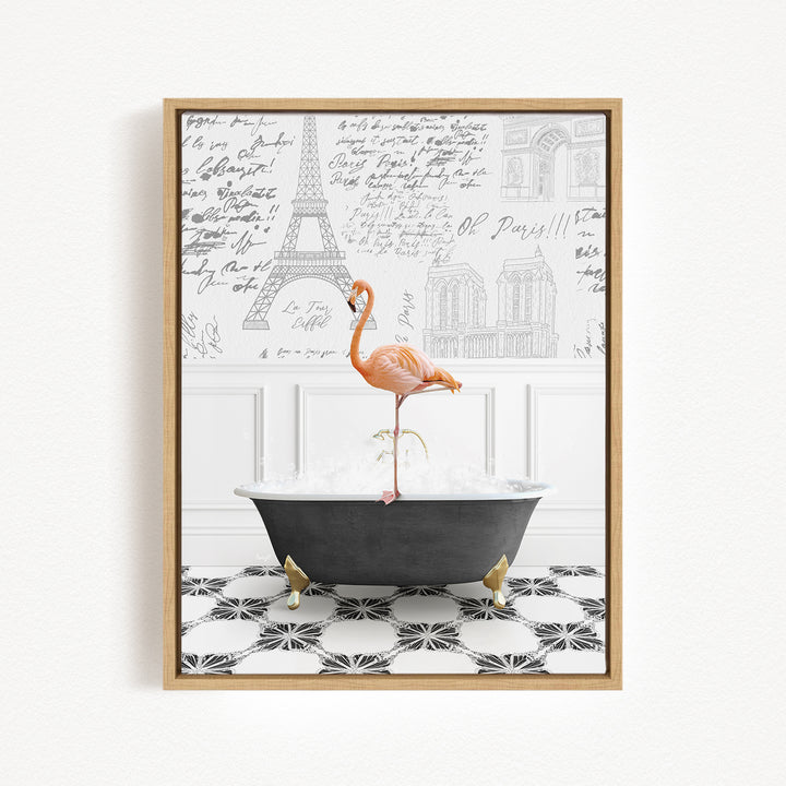 A framed image depicting a pink flamingo standing on a black bathtub filled with water, with a Paris-themed background featuring the Eiffel Tower and other Parisian architecture.