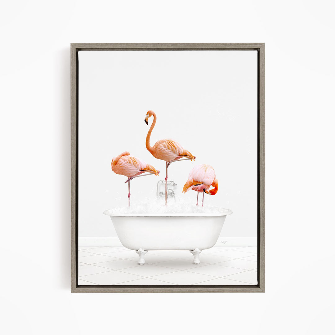 A framed image depicting three flamingos standing in a white bathtub filled with water.