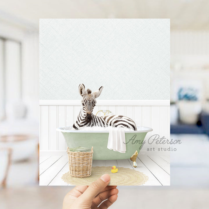 a person holding up a picture of a zebra in a bathtub