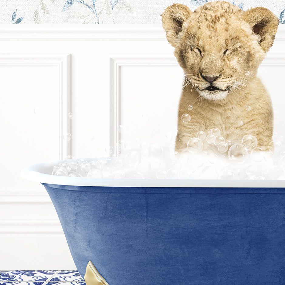 a lion cub sitting in a bathtub filled with foam