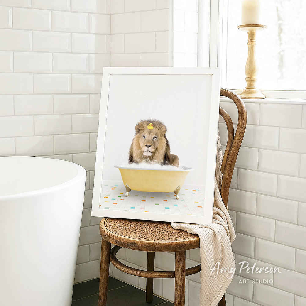 A framed image of a lion sitting in a bathtub, surrounded by colorful tiles, is displayed on a wooden chair in a bathroom.