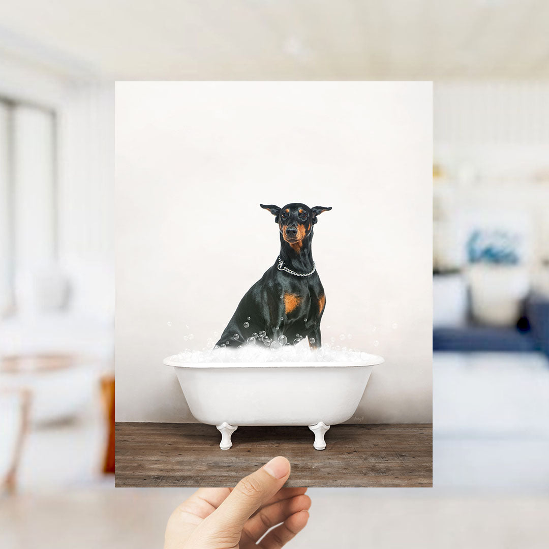 A small black and brown dog sitting in a white bathtub filled with water, with bubbles around it.