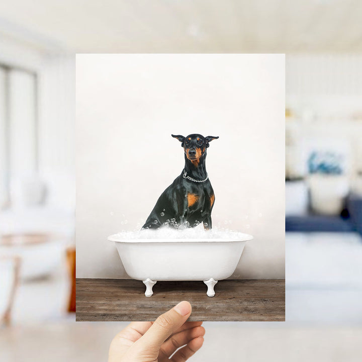 A small black and brown dog sitting in a white bathtub filled with water, with bubbles around it.