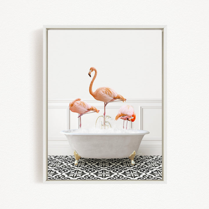 A framed image of three pink flamingos standing in a white bathtub filled with water, creating a whimsical and playful scene.