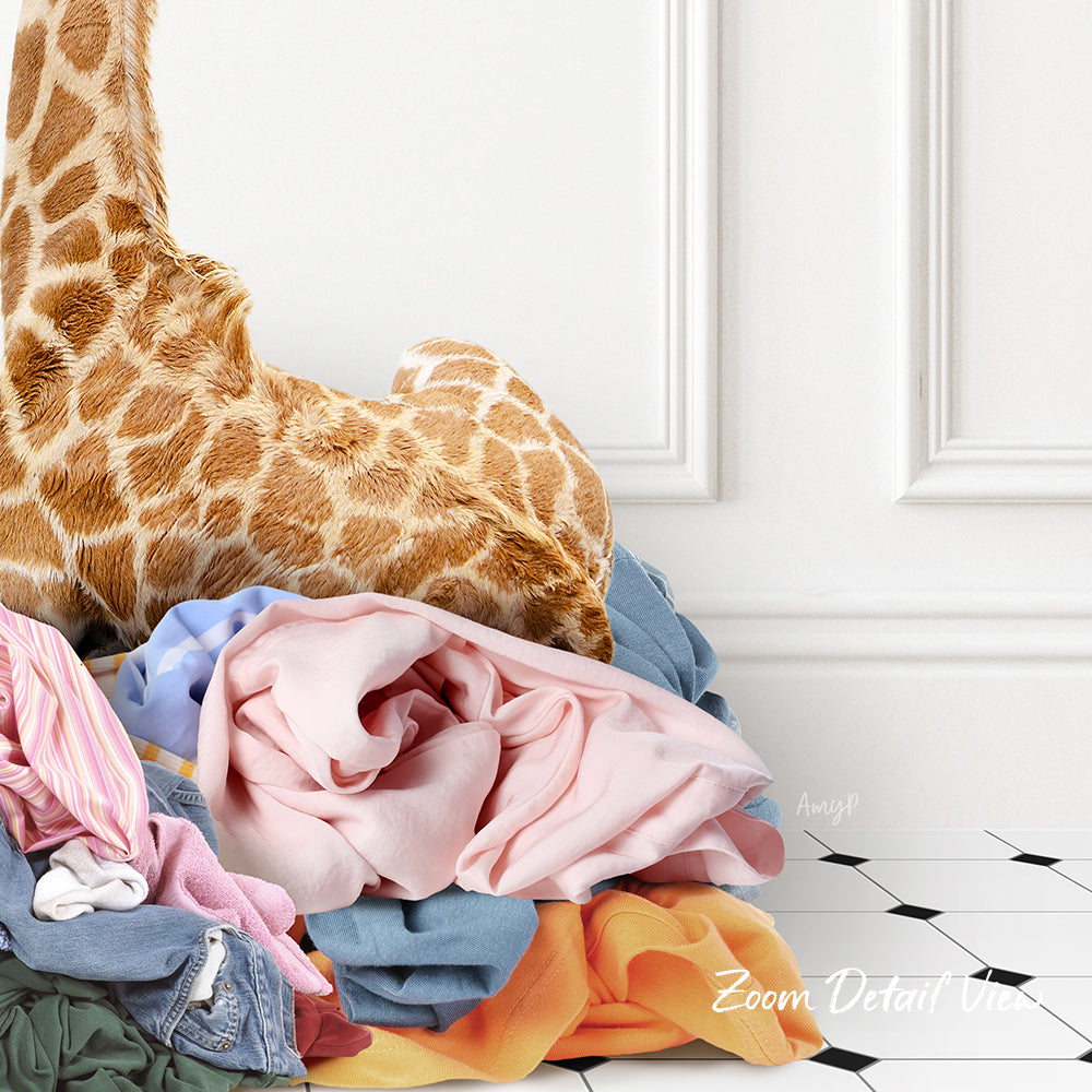 A pile of clothes, including a stuffed giraffe, is stacked on a white tiled floor against a white wall.