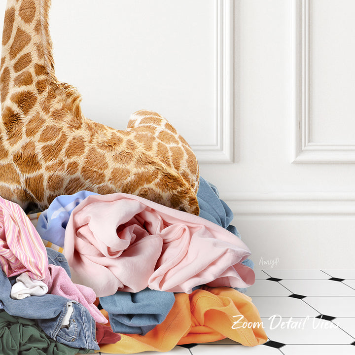 A pile of clothes, including a stuffed giraffe, is stacked on a white tiled floor against a white wall.