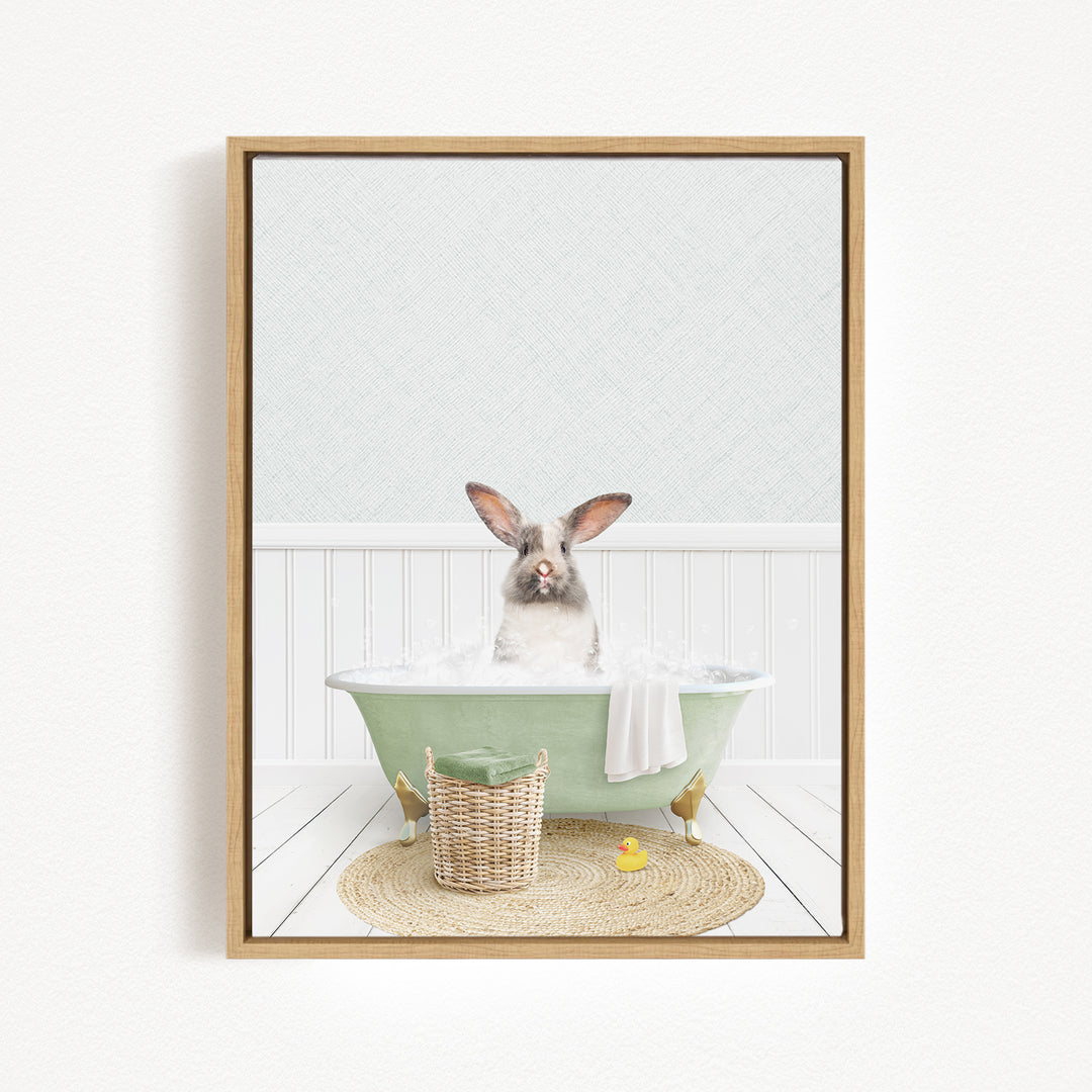 A rabbit sitting in a green bathtub filled with water, surrounded by a basket of toys and a yellow rubber duck.