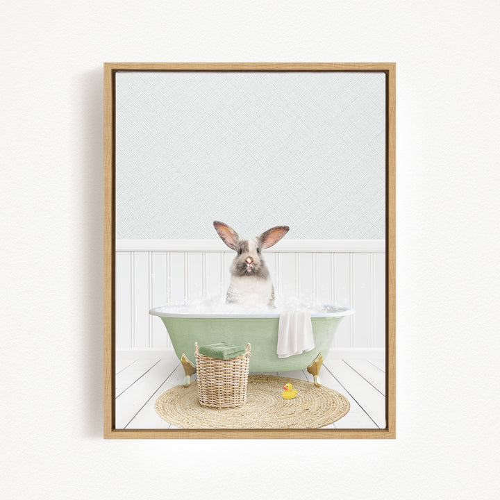 A rabbit sitting in a green bathtub filled with water, surrounded by a basket of toys and a yellow rubber duck.