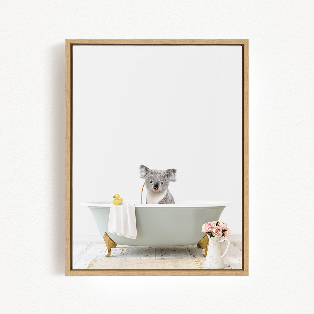 A koala bear sitting in a bathtub filled with water, surrounded by a yellow rubber duck and pink flowers.