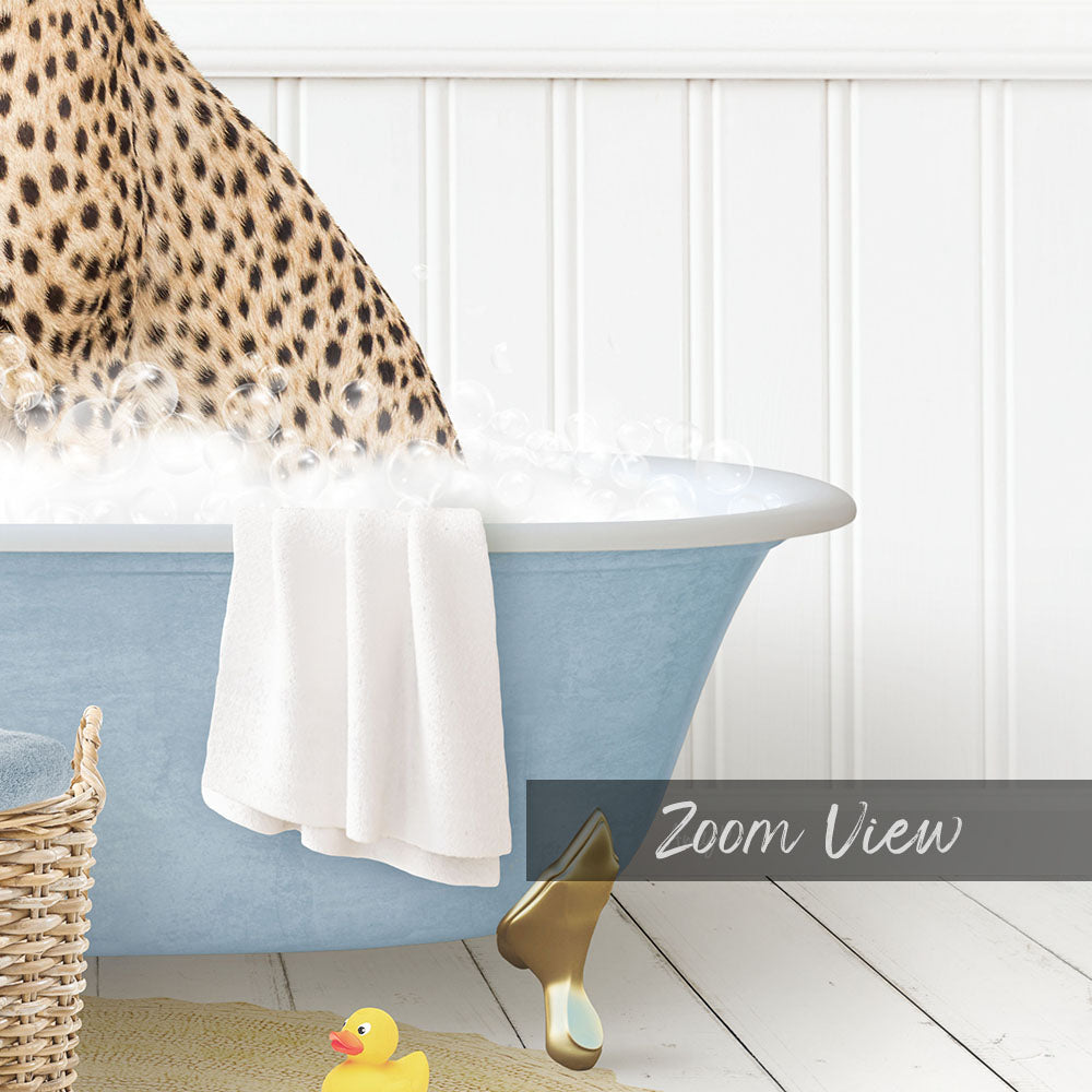 A leopard-print cat is sitting in a blue bathtub filled with water, with a yellow rubber duck nearby.
