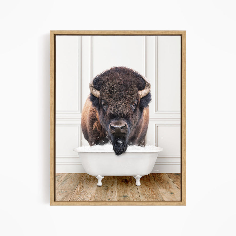 A buffalo with a black beard is standing in a white bathtub, looking directly at the camera.