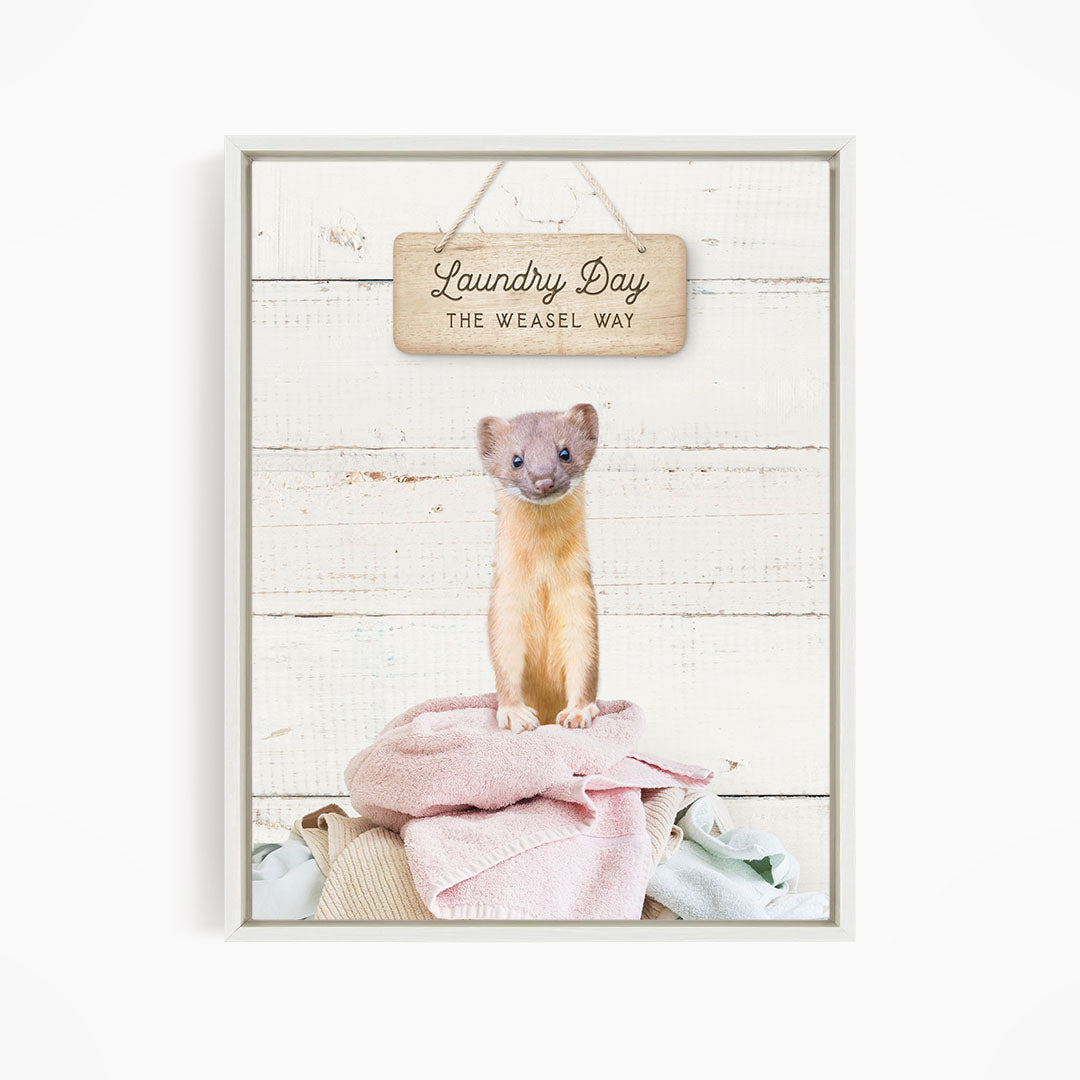 A weasel standing on a pile of clothes, with a wooden sign above that says "Laundry Day The Weasel Way".