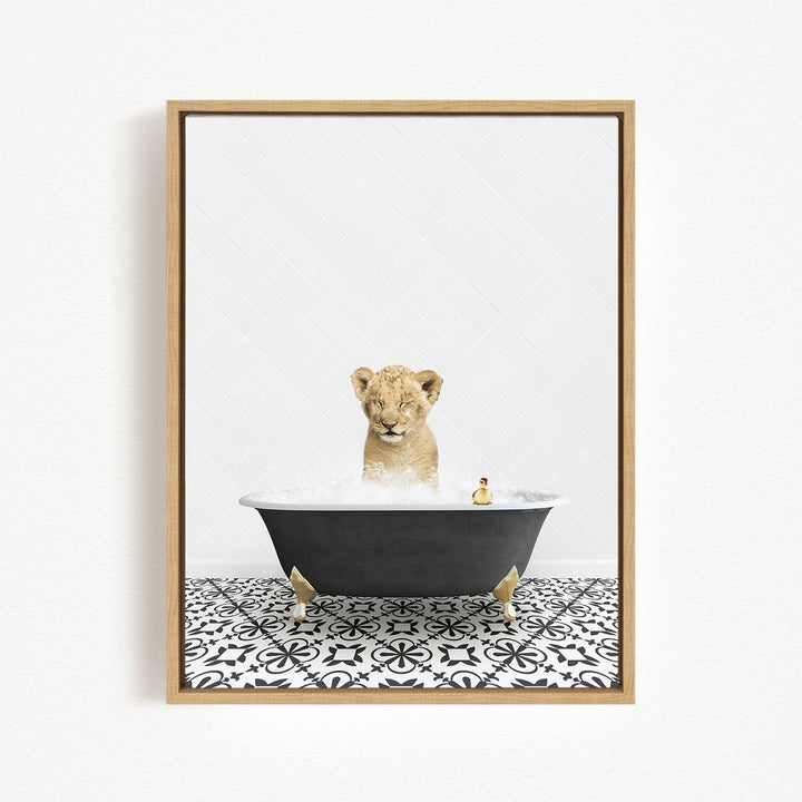 A young lion cub is sitting in a bathtub filled with water, surrounded by a black and white patterned floor.