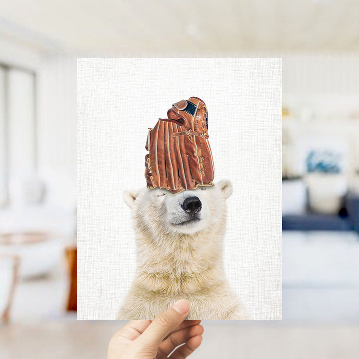 A polar bear wearing a baseball glove on its head, with a blurred background suggesting a room setting.