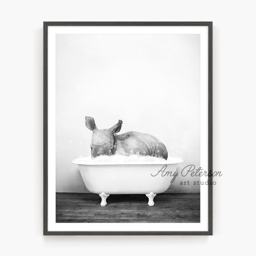 a black and white photo of a bunny in a bathtub